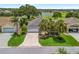Aerial view of home showcasing well-maintained landscaping, a golf course view, and mature trees at 1266 James Island St, The Villages, FL 32162