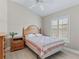 Cozy bedroom featuring a comfortable bed, shuttered windows, and neutral decor at 1266 James Island St, The Villages, FL 32162