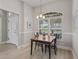 Bright dining area featuring a chandelier and large windows with backyard views at 1266 James Island St, The Villages, FL 32162