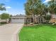 Charming home with well-manicured lawn, mature palm trees, and inviting front entrance at 1266 James Island St, The Villages, FL 32162