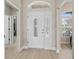 Welcoming foyer featuring decorative glass front door and sidelights, enhancing natural light at 1266 James Island St, The Villages, FL 32162