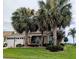 Charming home with mature palm trees and a well-maintained front yard at 1266 James Island St, The Villages, FL 32162