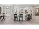 Spacious open-concept kitchen with ample counter seating and views of the foyer and dining area at 1266 James Island St, The Villages, FL 32162