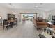 Bright living room featuring a dining area, comfortable seating, and a beautiful view of the outdoors at 1266 James Island St, The Villages, FL 32162