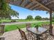 Enjoy outdoor dining on the covered patio with views of the lush green golf course at 1266 James Island St, The Villages, FL 32162
