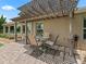 Charming outdoor patio with seating under a pergola with string lights at 1266 James Island St, The Villages, FL 32162