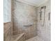 Walk-in shower features grab bar and tiled walls and floor at 1266 James Island St, The Villages, FL 32162