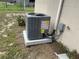 A modern, gray air conditioner unit sits outside a home, ensuring efficient cooling and climate control at 145 Ne 71St Ave, Ocala, FL 34470