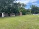 A large backyard with various outbuildings, chicken coop, and an above-ground pool at 145 Ne 71St Ave, Ocala, FL 34470