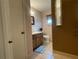Bathroom featuring a wooden vanity, mirror, and tiled floor at 145 Ne 71St Ave, Ocala, FL 34470