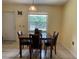 Dining area featuring tile flooring, a modern light fixture, and a view to the backyard at 145 Ne 71St Ave, Ocala, FL 34470