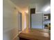 Hallway leading to kitchen area, featuring light walls and tile flooring at 145 Ne 71St Ave, Ocala, FL 34470