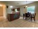 Eat in kitchen featuring an island, tile flooring, and a view to the backyard at 145 Ne 71St Ave, Ocala, FL 34470