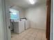 Convenient laundry room with washer, dryer, and storage shelving at 145 Ne 71St Ave, Ocala, FL 34470