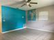 Bright living room features tile flooring, ceiling fan, and a vibrant accent wall at 145 Ne 71St Ave, Ocala, FL 34470
