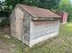 Wooden outbuilding with a red shingle roof in the backyard of the property at 145 Ne 71St Ave, Ocala, FL 34470