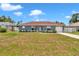 Front view of the one story home with a well maintained lawn, white-framed windows and an attached one car garage at 14762 Sw 22Nd Court Rd, Ocala, FL 34473