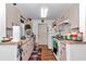 Kitchen with light pink countertops and cabinets, wood-look floors, and white appliances at 14762 Sw 22Nd Court Rd, Ocala, FL 34473