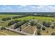 Aerial view showcasing a large property with expansive green fields and mature trees at 15360 Se 73Rd Avenue, Summerfield, FL 34491