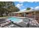 Relaxing backyard pool with gold fish mosaic and covered patio with outdoor bar at 15360 Se 73Rd Avenue, Summerfield, FL 34491