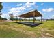 Open air carport with a metal roof and concrete base is perfect for vehicles or outdoor equipment at 15360 Se 73Rd Avenue, Summerfield, FL 34491