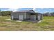 Exterior shot of building with roll up door and entry door, with covered area at entrance at 15360 Se 73Rd Avenue, Summerfield, FL 34491