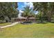 Ranch home with a sparkling pool, large front yard and mature landscaping at 15360 Se 73Rd Avenue, Summerfield, FL 34491