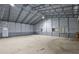 Bright, spacious garage interior with tall ceilings, roll up doors, and concrete flooring at 15360 Se 73Rd Avenue, Summerfield, FL 34491
