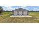 Three car gray garage with metal roof and siding, perfect for the car collector and mechanic at 15360 Se 73Rd Avenue, Summerfield, FL 34491