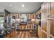 Well-equipped kitchen with wood cabinets, stainless steel appliances, brick backsplash, and granite countertops at 15360 Se 73Rd Avenue, Summerfield, FL 34491