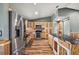 Stylish kitchen featuring stainless steel appliances, custom wood cabinetry, and a central island with counter seating at 15360 Se 73Rd Avenue, Summerfield, FL 34491
