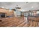 Open living space with fireplace and view of the kitchen featuring wood-look floors and trim and stylish accents at 15360 Se 73Rd Avenue, Summerfield, FL 34491