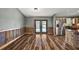 Bright living space with wood-look floors, opening to the kitchen and offering views of the backyard pool at 15360 Se 73Rd Avenue, Summerfield, FL 34491