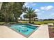 Pool surrounded by landscaped yard and mature trees and distant barn at 15360 Se 73Rd Avenue, Summerfield, FL 34491