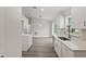 Open kitchen and dining area features wood-look flooring, bright white cabinets, and modern lighting at 15369 Sw 38Th Pl, Ocala, FL 34481