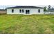 Large backyard area with ample green space and a patio door on the back of the home at 1686 Sw 168Th Loop, Ocala, FL 34473