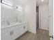 Well-lit bathroom with double vanity, modern fixtures, and a glass-enclosed shower at 1686 Sw 168Th Loop, Ocala, FL 34473