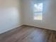 Bedroom featuring wood-look floors and a window that provides natural light at 1686 Sw 168Th Loop, Ocala, FL 34473