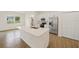 Bright kitchen featuring an island, stainless steel appliances, white cabinets, and tile floors at 1686 Sw 168Th Loop, Ocala, FL 34473