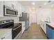 Modern kitchen with stainless steel appliances, ample counter space, and bright lighting at 1686 Sw 168Th Loop, Ocala, FL 34473