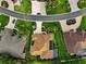 Home aerial view highlighting the manicured lawn, gardens, and mature landscaping at 1953 Hartford Path, The Villages, FL 32162