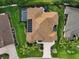 Aerial view of a home showcasing an expansive backyard, pool, and meticulously maintained lawn at 1953 Hartford Path, The Villages, FL 32162
