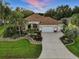 Aerial of a lovely home with well-maintained landscaping, and a spacious driveway at 1953 Hartford Path, The Villages, FL 32162