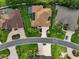 Overhead view of a house with a green lawn, mature trees, a screened-in pool, and a patio at 1953 Hartford Path, The Villages, FL 32162