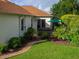 Backyard featuring a hot tub, lush landscaping, and a well-manicured lawn, perfect for relaxation and outdoor enjoyment at 1953 Hartford Path, The Villages, FL 32162