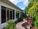 Landscaped backyard oasis with fountain and garden benches, creating a tranquil outdoor living space at 1953 Hartford Path, The Villages, FL 32162