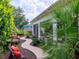 Lush backyard featuring a stone water feature and winding walkway offering relaxation and charm at 1953 Hartford Path, The Villages, FL 32162
