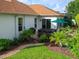 Backyard featuring a hot tub, lush landscaping, and a well-manicured lawn, perfect for relaxation and outdoor enjoyment at 1953 Hartford Path, The Villages, FL 32162