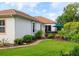 Backyard featuring a hot tub, lush landscaping, and a well-manicured lawn, perfect for relaxation and outdoor enjoyment at 1953 Hartford Path, The Villages, FL 32162