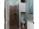 Updated bathroom features tiled shower and a modern vanity and toilet at 1953 Hartford Path, The Villages, FL 32162